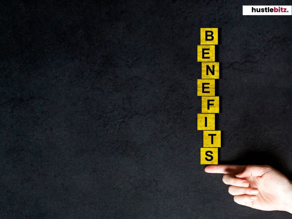 A hand balancing a blocks stack to each other that spelled "BENEFITS"