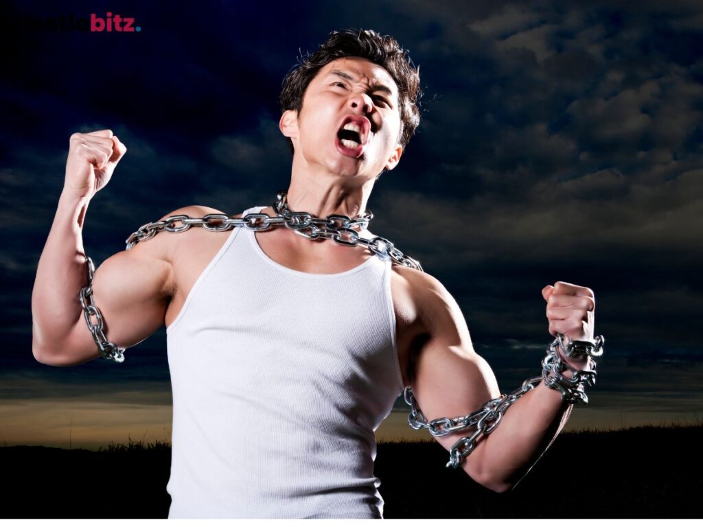 A man in chains breaks free, expressing strength and defiance.