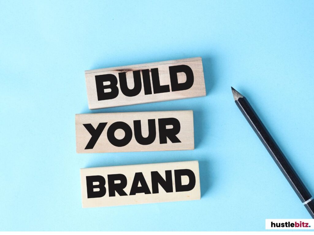 Wooden blocks spell "Build Your Brand" with a pencil on a light blue background.