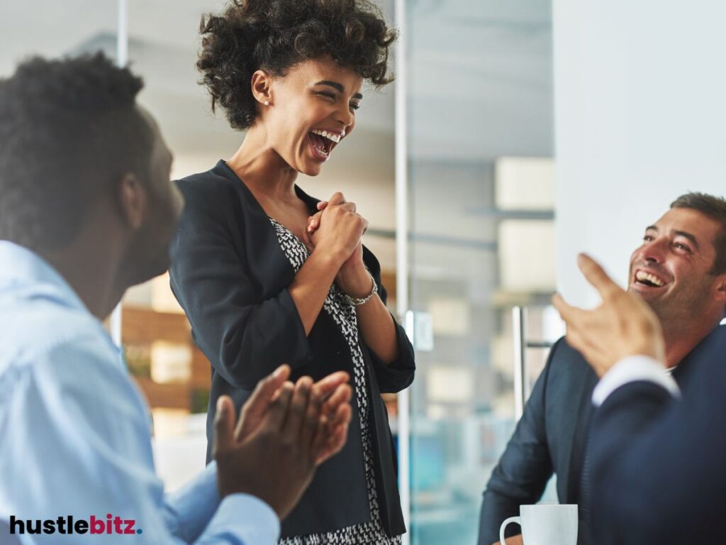 A group of employees clapping for their colleague.