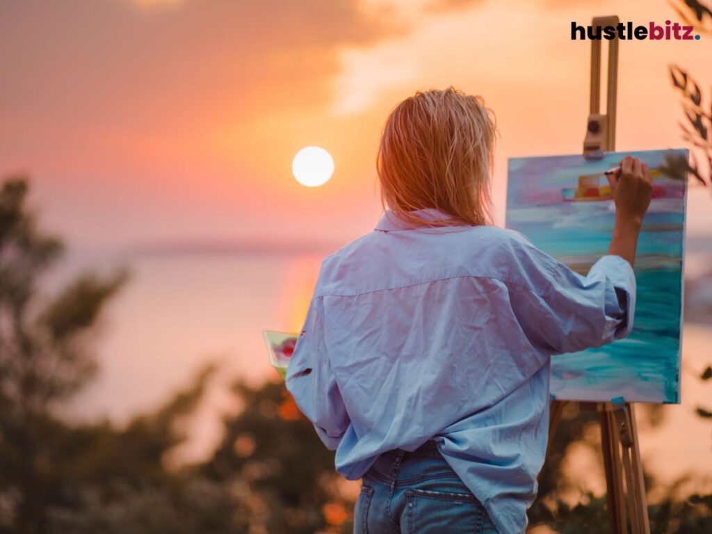 A woman paints at sunset, blending creativity with nature's beauty.