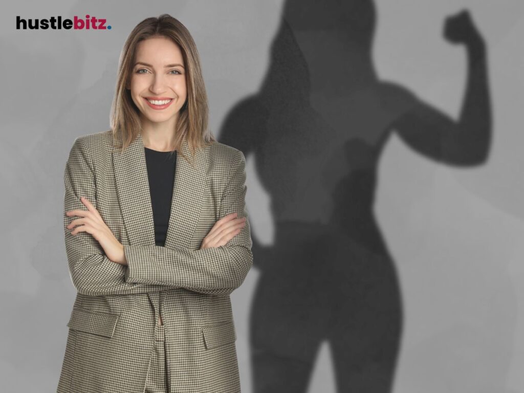 A smiling woman stands confidently, with a shadow flexing strong muscles.