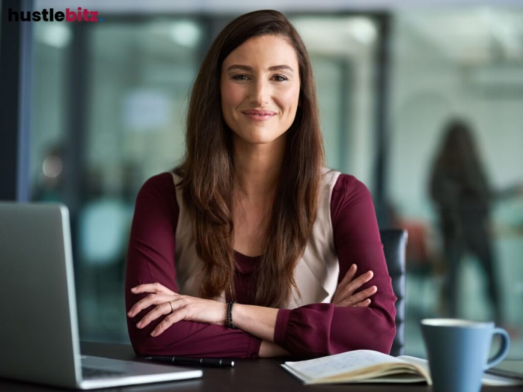 a woman smiles in front of the camera inside the office