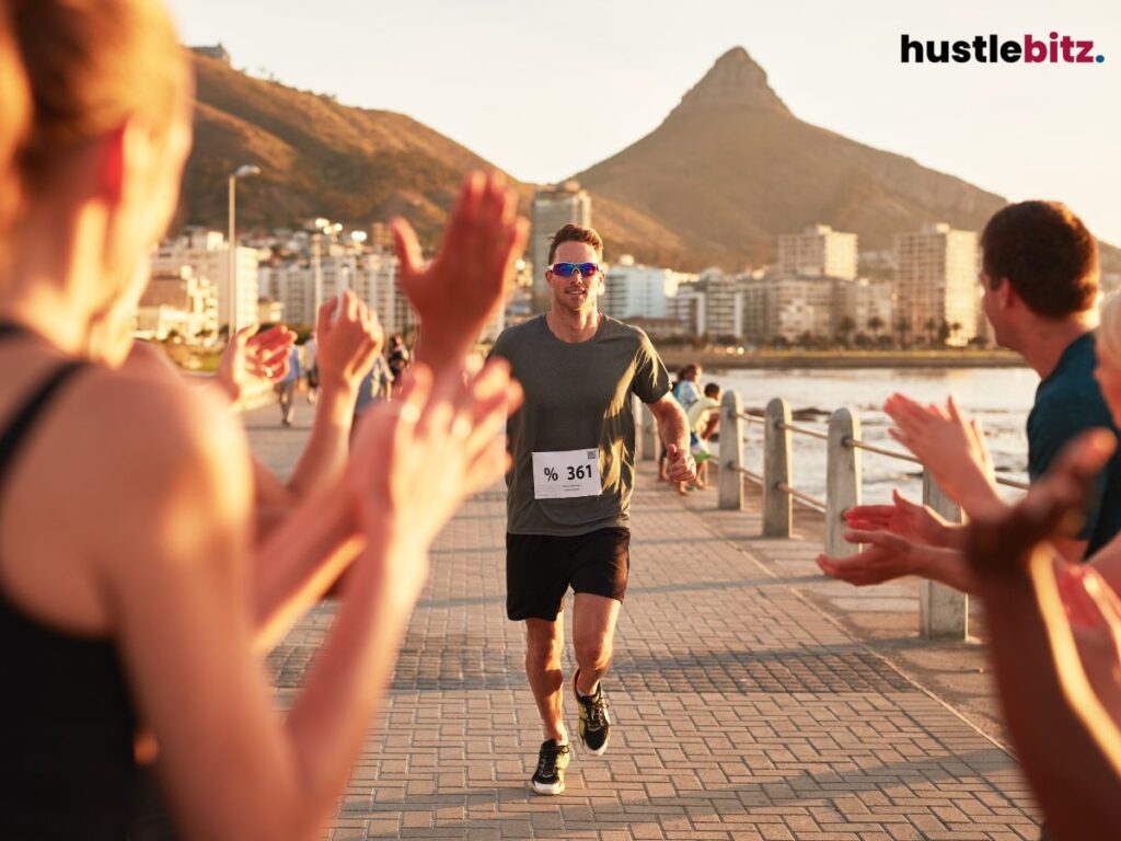Runner being cheered on by the crowd as he approaches the finish line.