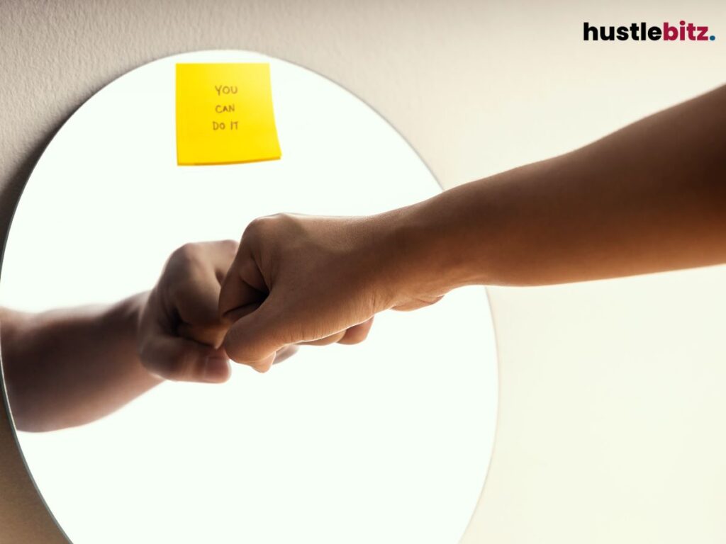 A person doing a Fist bump in the mirror with 'You Can Do It' note.