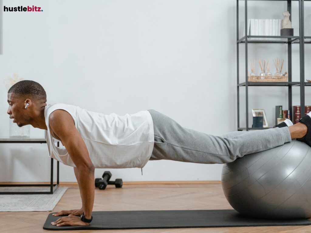 A man doing a push-up using an exercise ball in a minimalist room.