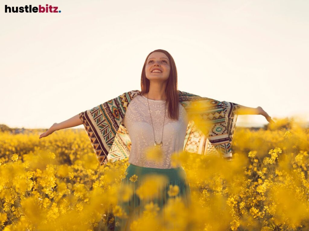 A woman raise her two hand and feel the nature