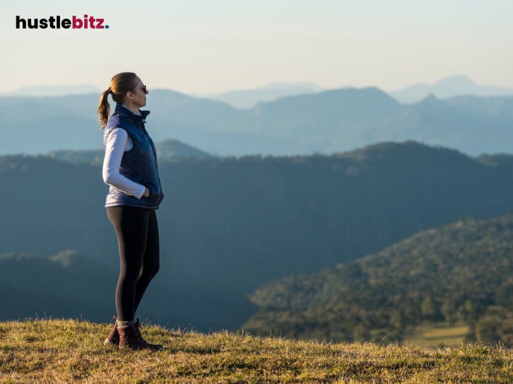 A woman wearing eyeglass looking at the mountains