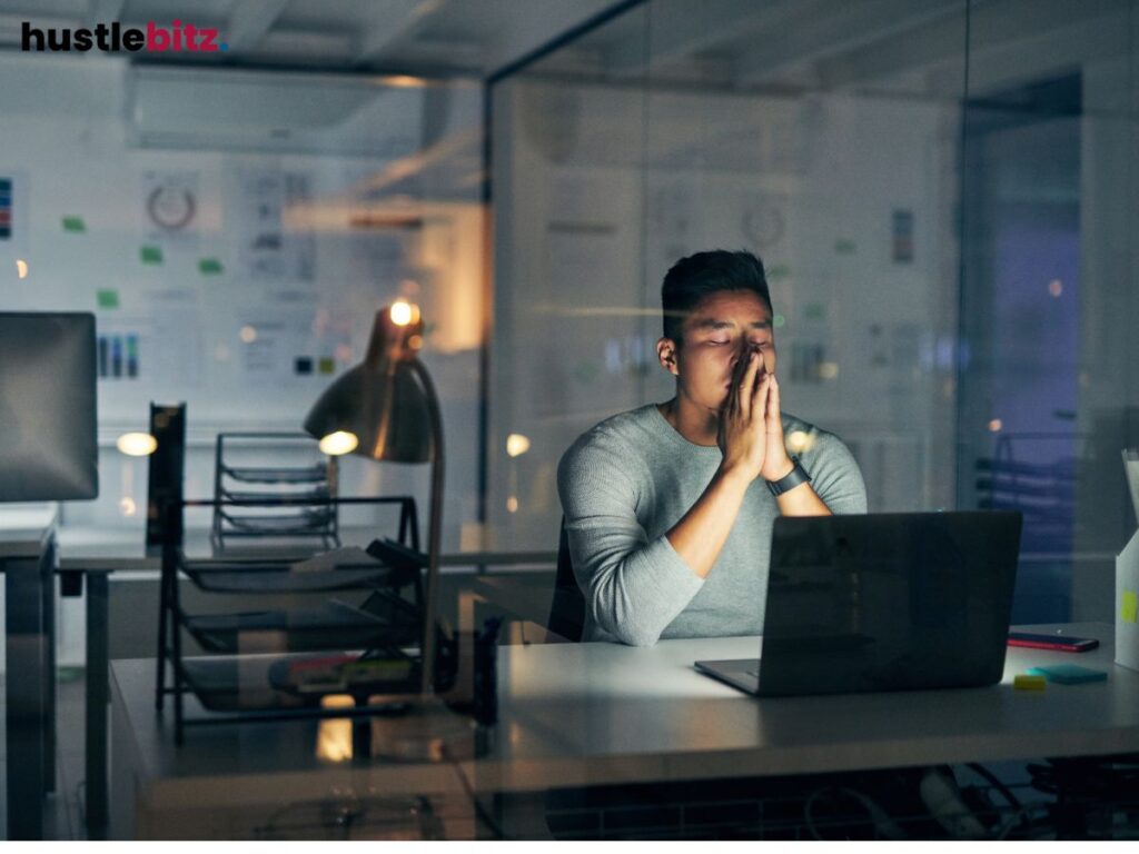 Person in deep thought, sitting in an office, contemplating decisions and outcomes.