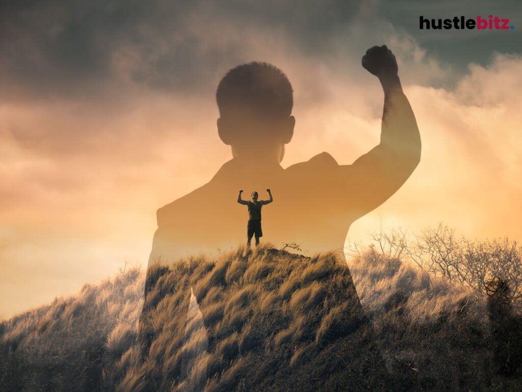 A man raise his two hands showing victorious in the mountain
