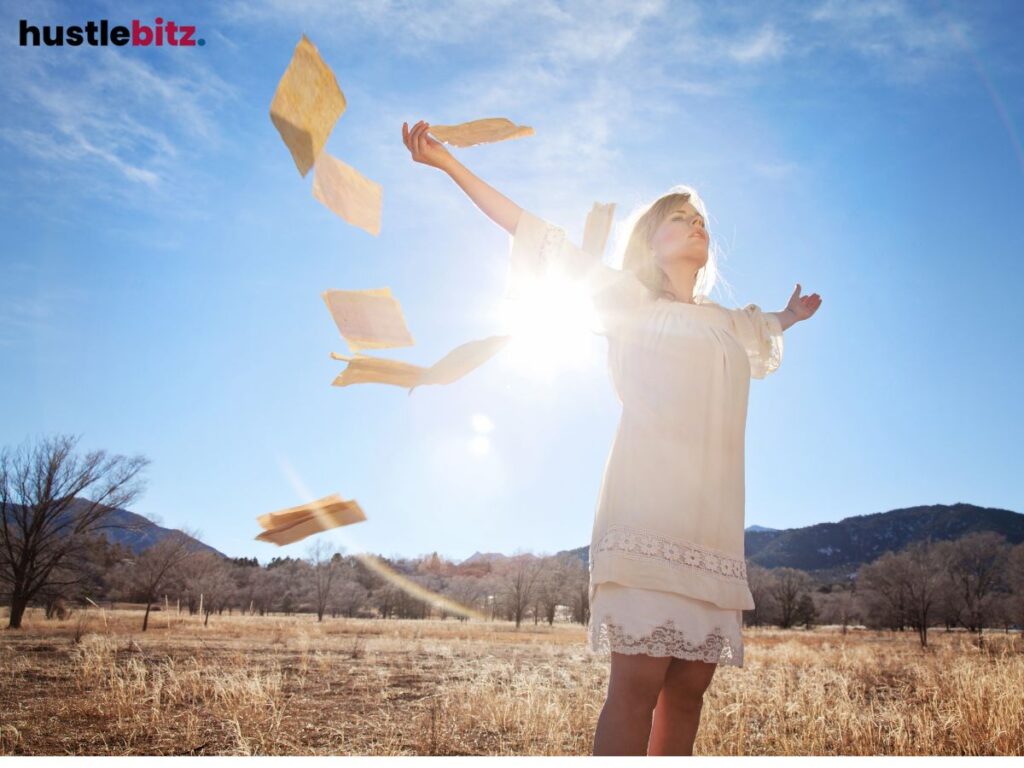 A woman raise her two hands feel the wind