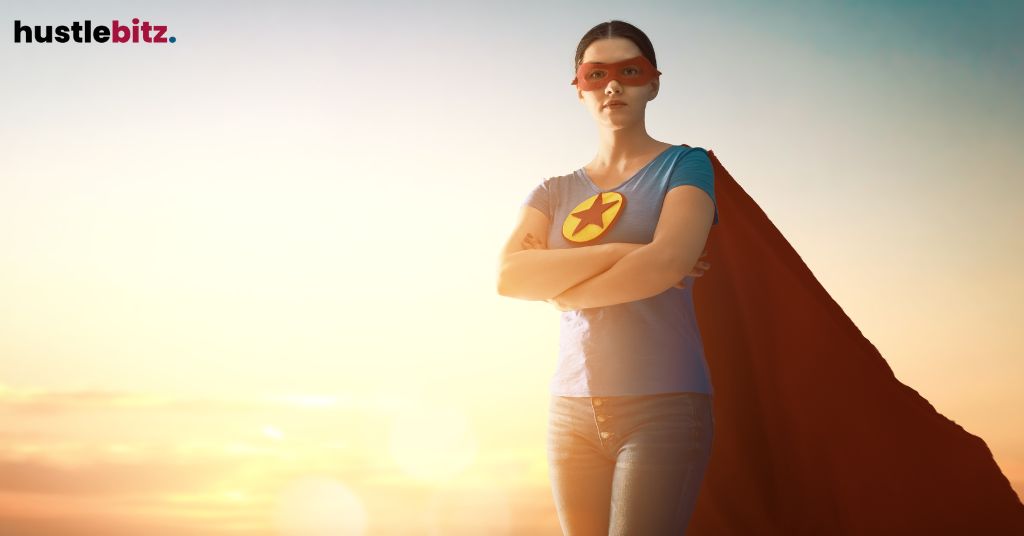 A woman dressed as a superhero, standing confidently with a cape and mask.