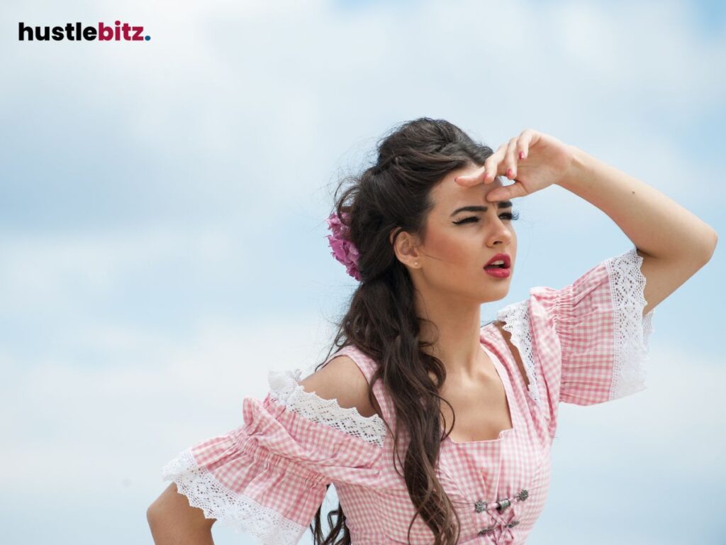 Woman shielding her eyes from the sun, looking into the distance.