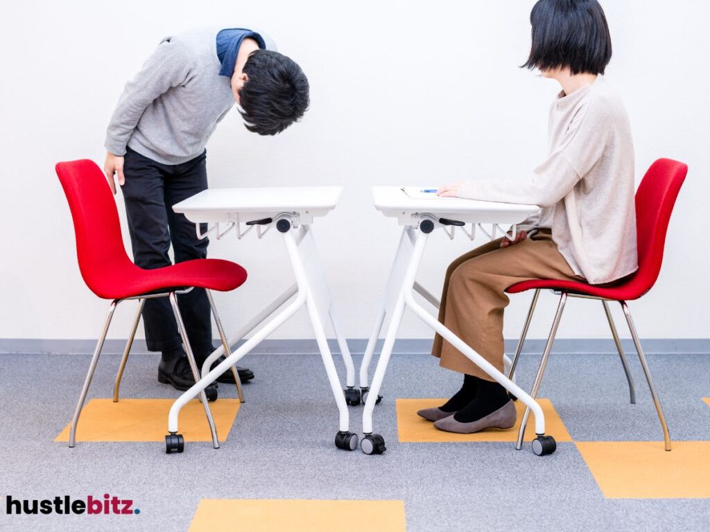 Man bowing to seated woman - a sign of respect.