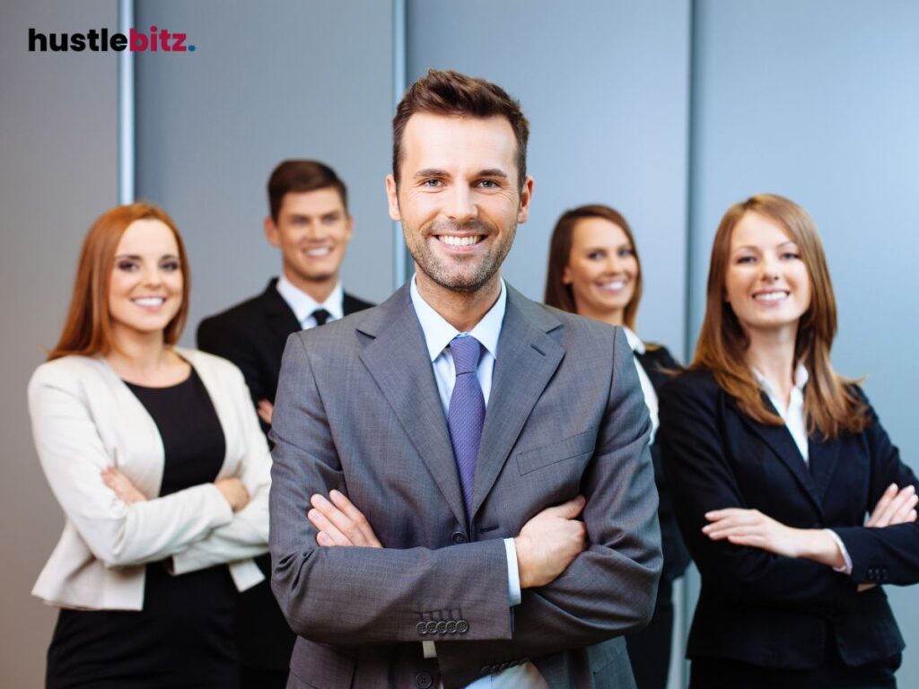 A group of people wearing suit smiles while taking picture