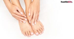 A close up of a woman's hands touching her feet.