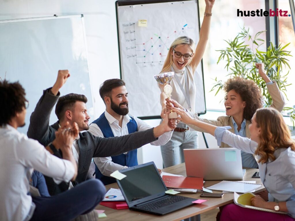 A group of people smiles while holding a trophy
