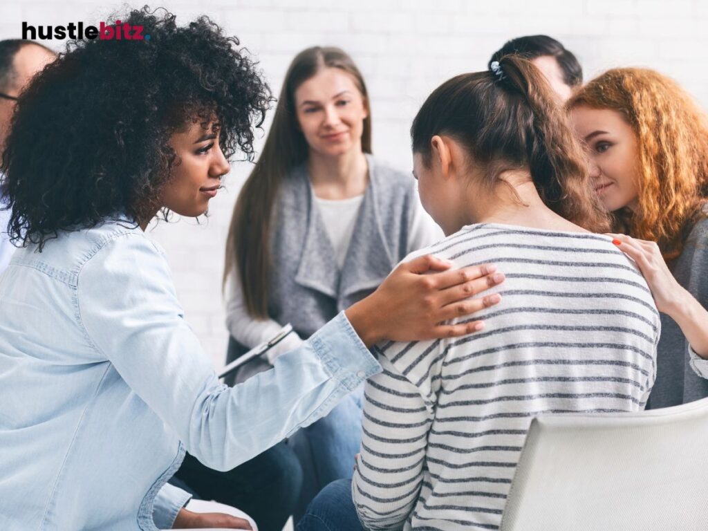 A group of people doing comfort to the woman