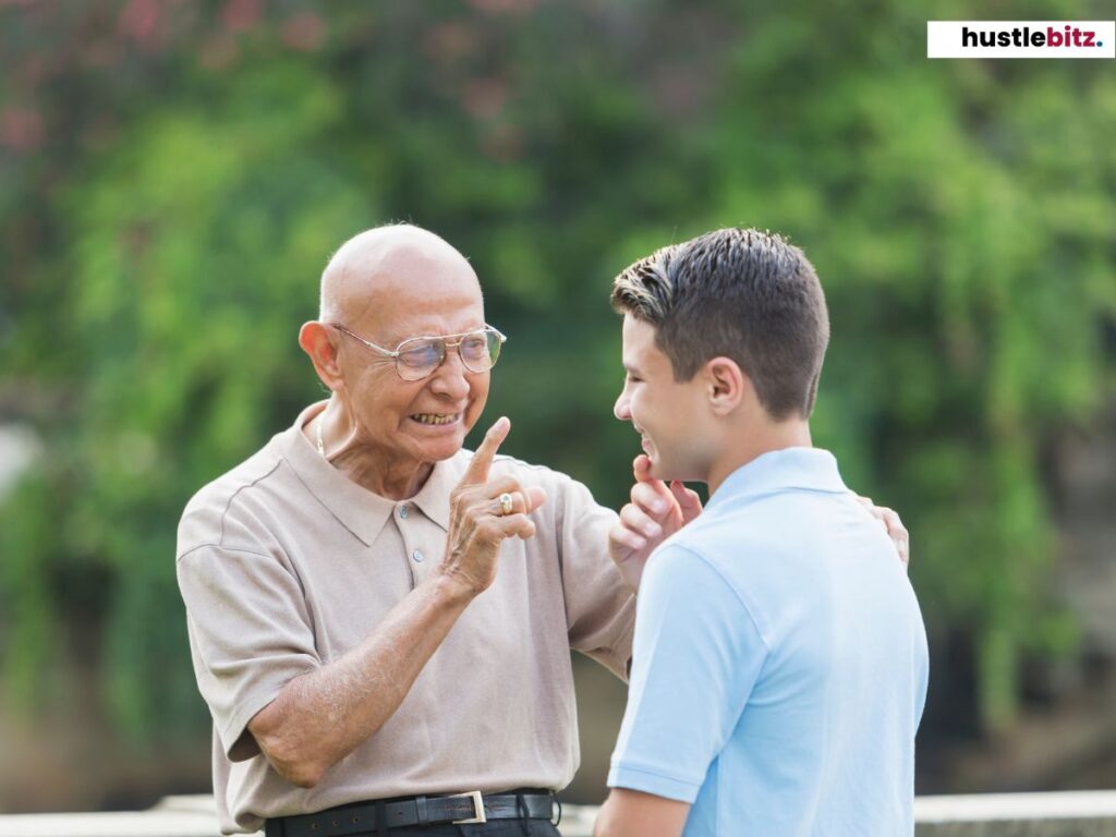 An elderly man giving an advice to a young man.