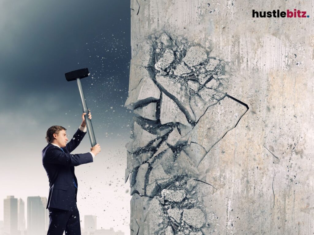 A man holding a hammer going to destroy the wall concrete