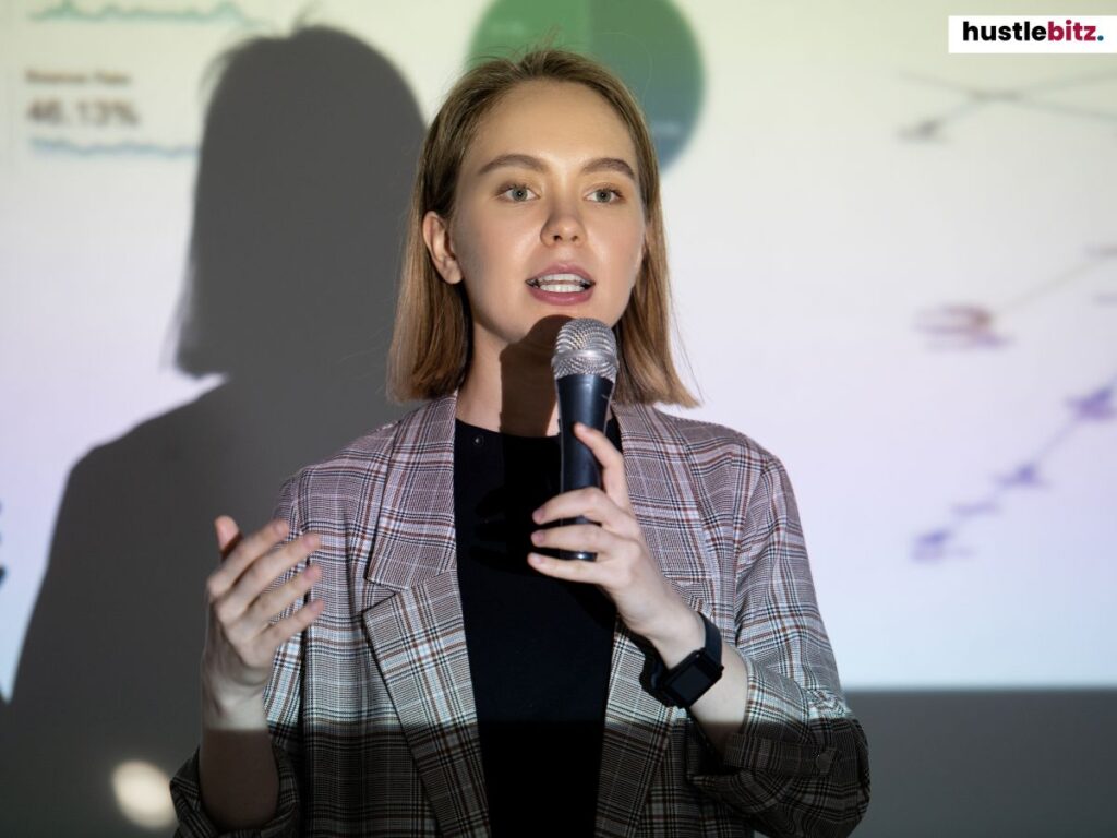 A woman in business attire delivering a presentation.
