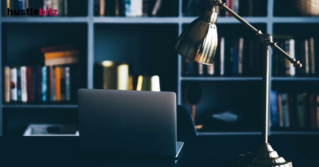 A picture of an office and a laptop in the table