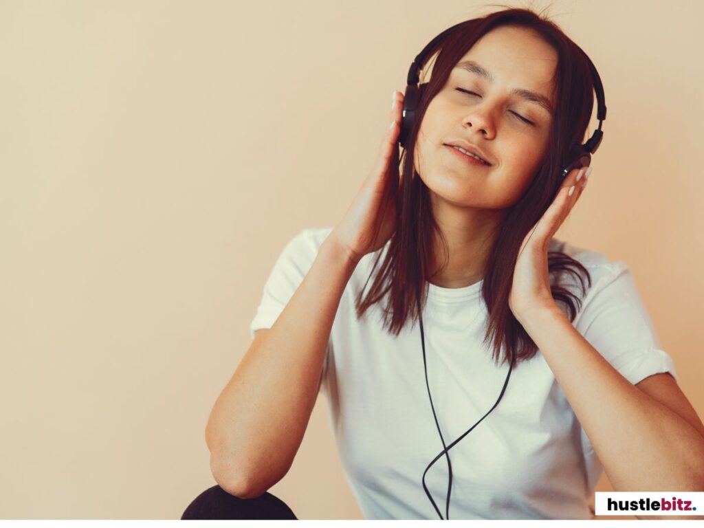 Close-up of a woman enjoying music with headphones, eyes closed.