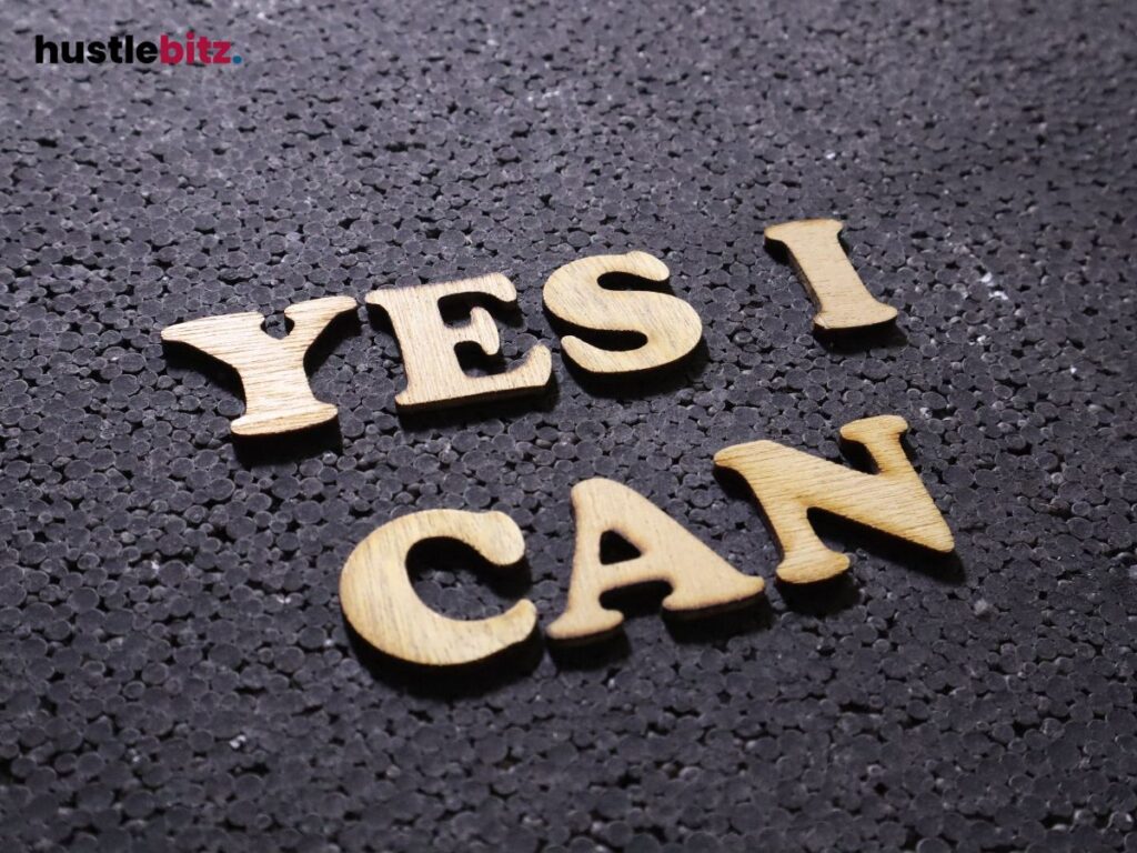 Wooden letters spelling 'YES I CAN' on a dark textured surface.
