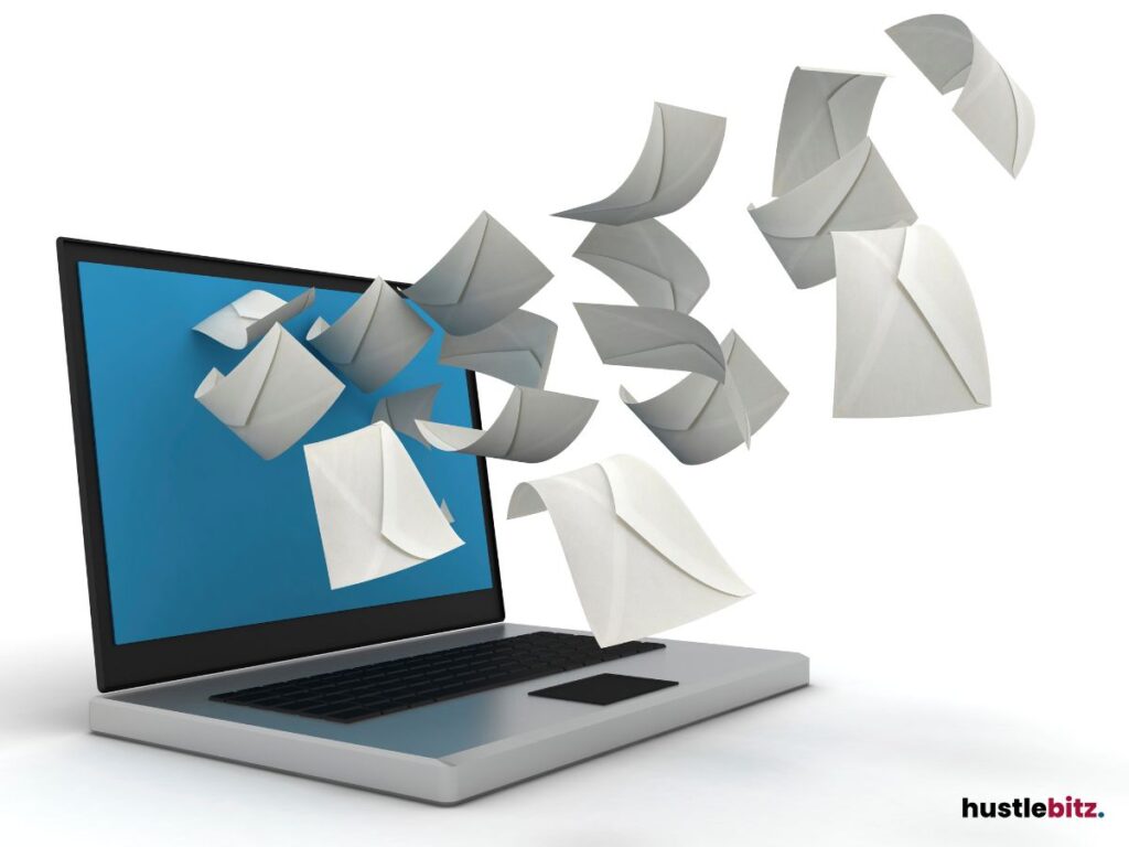 Emails are flying out of a laptop, depicting an active inbox.