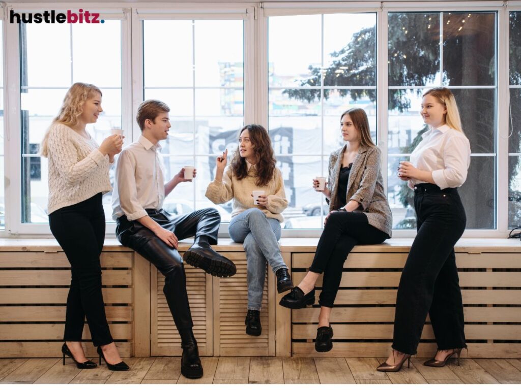 Group of people having a friendly conversation while drinking coffee.