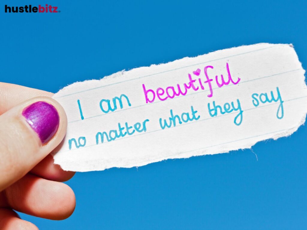 A finger of a person holding a paper with quotes