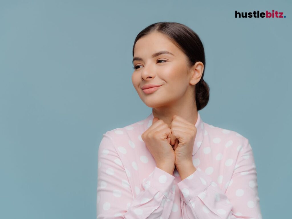 A woman at ease smiling in a blue background.