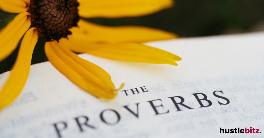 "The Proverbs" page from a book, with a yellow flower petal above.