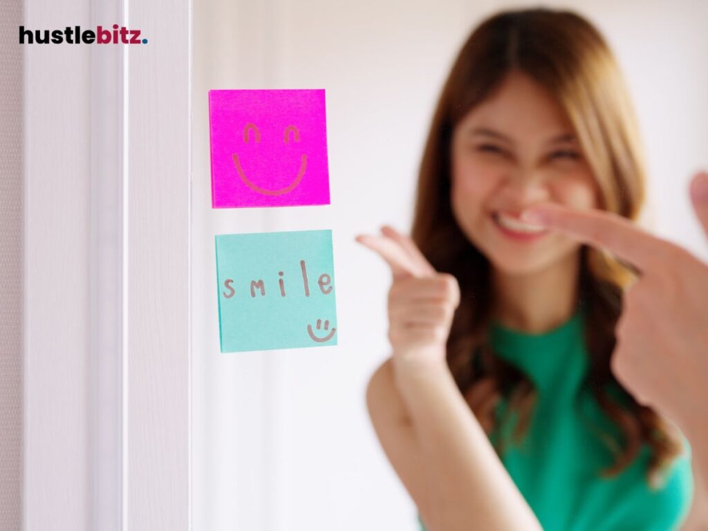 A woman smiles while pointing at post-it notes saying "smile" with a happy face.