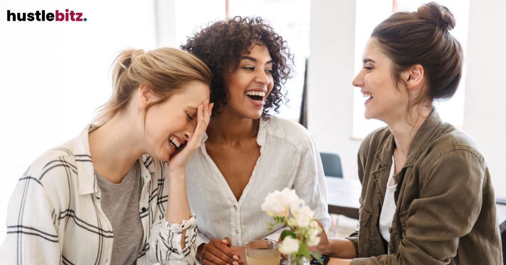 Three ladies laughing together in the office.
