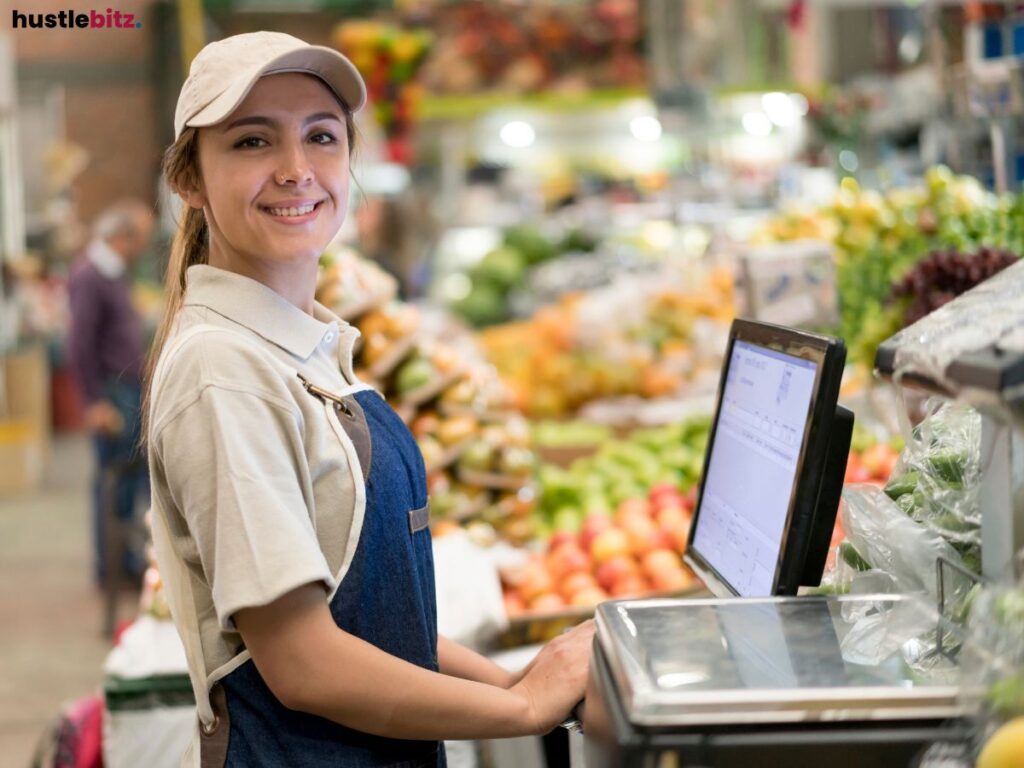 A cashier woman smiling on the camera.