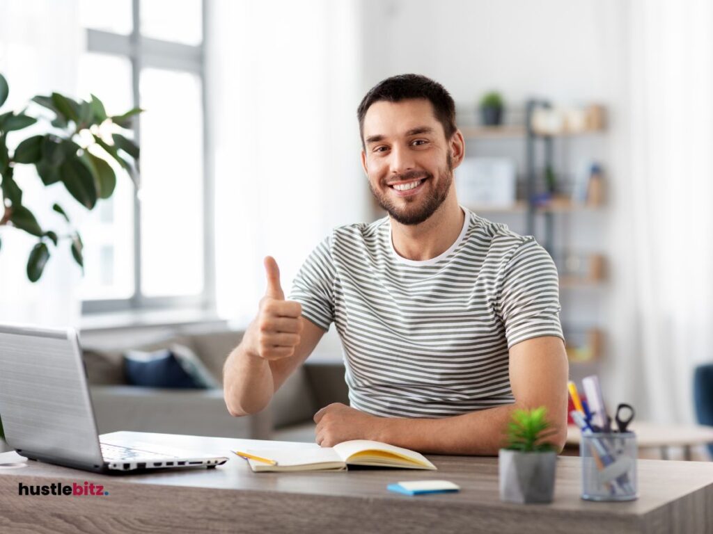 A man thumbs up in the camera and smiles