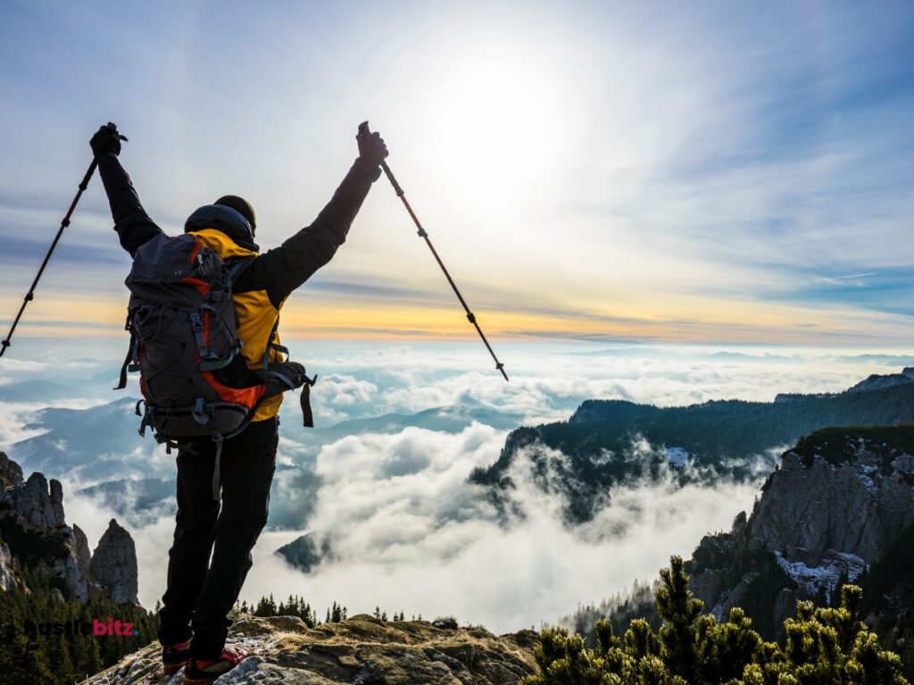 A man up his 2 hands and a mountain background