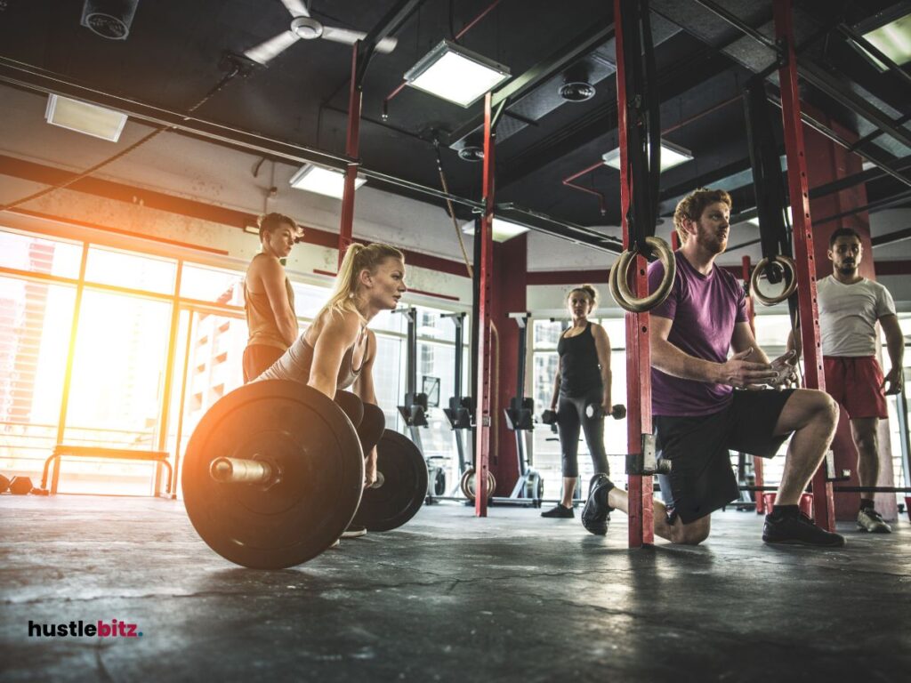 A group of people doing exercise inside the gym