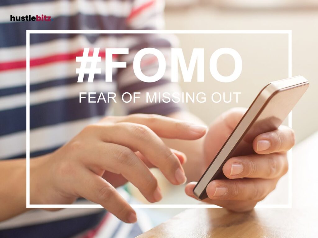 A man using gadgets with a word FOMO