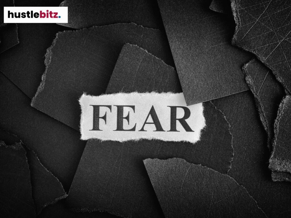 The word "FEAR" appears on torn black paper, highlighting a sense of uncertainty.

