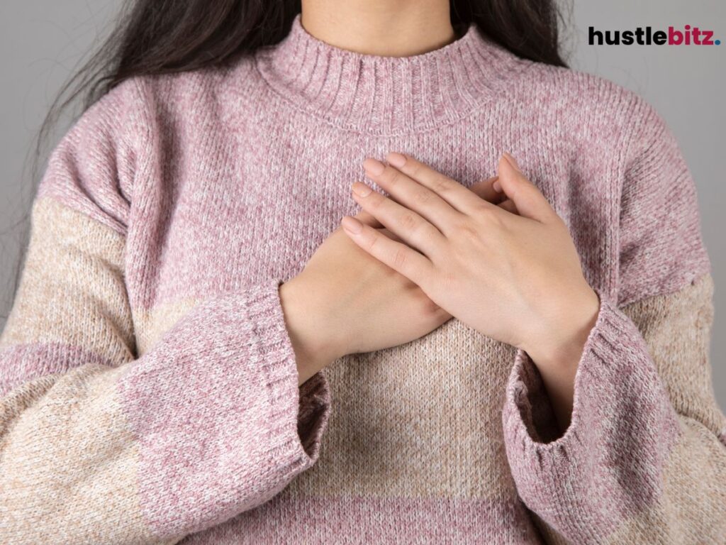 Hands rest on the heart, expressing warmth, gratitude, and self-love.