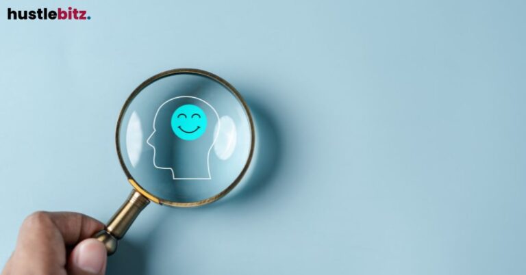 A happy face inside a silhouette, highlighted with a magnifying glass.