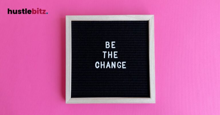 A black letterboard reads "BE THE CHANGE" against a bright pink background.