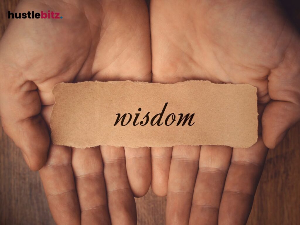 Hands gently hold a torn paper with the word "wisdom" written on it.


