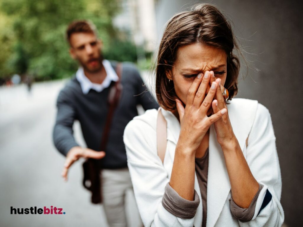 A woman cries while a man reaches out to her, showing emotional conflict.