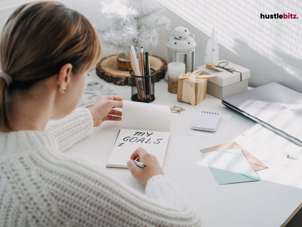 A woman in the table writing about her goals