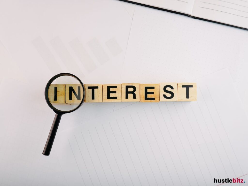 A magnifying glass and wooden blocks with the word INTEREST