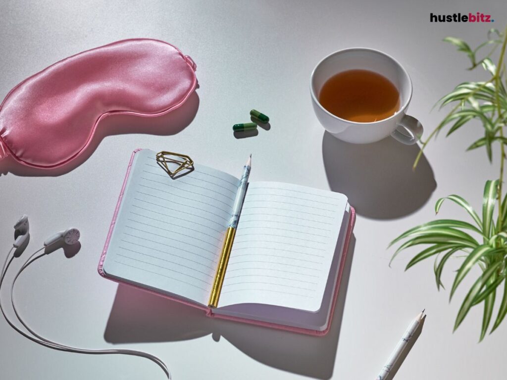 A notebook, sleeping mask, medicine, and tea