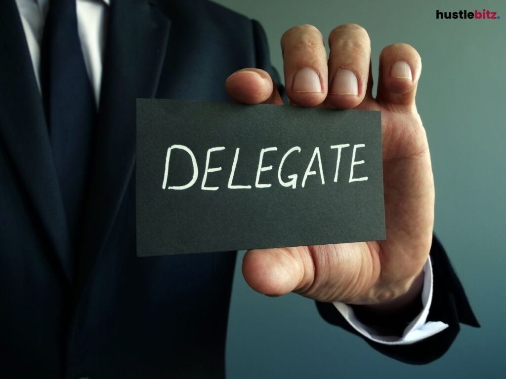 A person holding a black paper with  the word DELEGATE